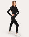 Front right three-quarter view of black long-sleeve women’s jumpsuit with zip neck