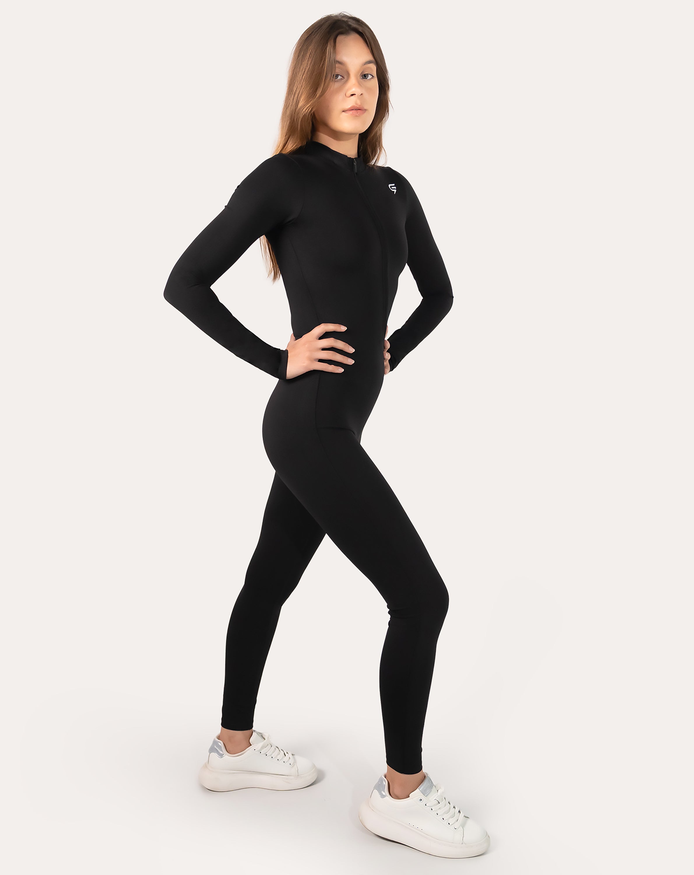 Front right three-quarter view of black long-sleeve women’s jumpsuit with zip neck