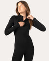 Right three-quarter standing pose in black long-sleeve women’s jumpsuit, contoured fit