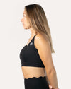 Right side profile of black padded sports bra showing smooth knit and supportive underband