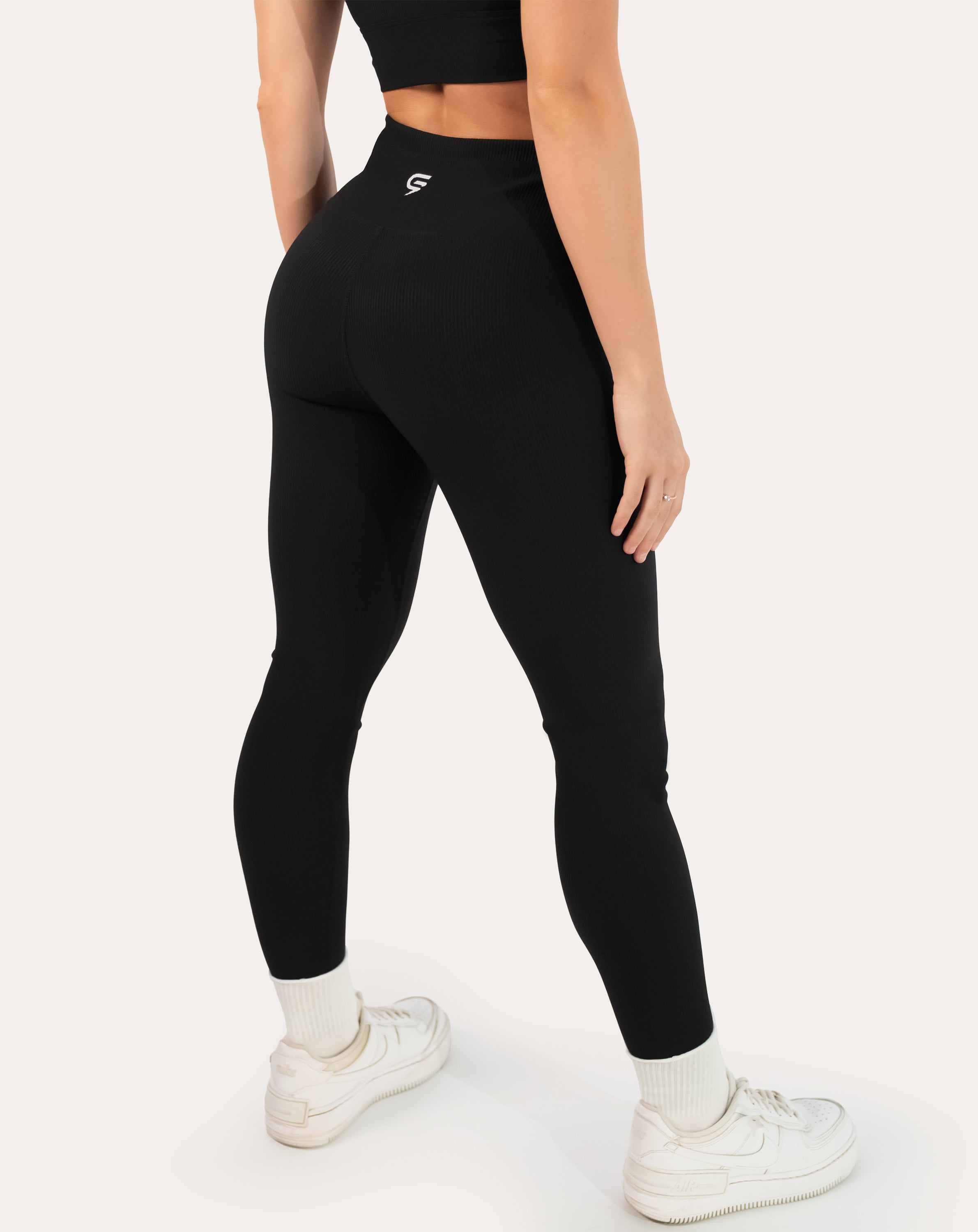 Black ribbed leggings with high-rise waistband; back right three quarter view