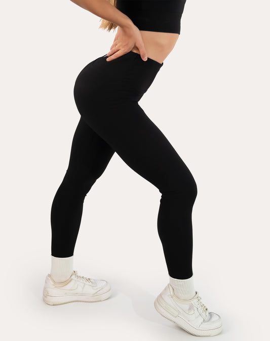 Black ribbed leggings with seamless high-rise waistband; left three quarter view