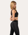 Right side profile of black running sports bra highlighting square neck and supportive underband