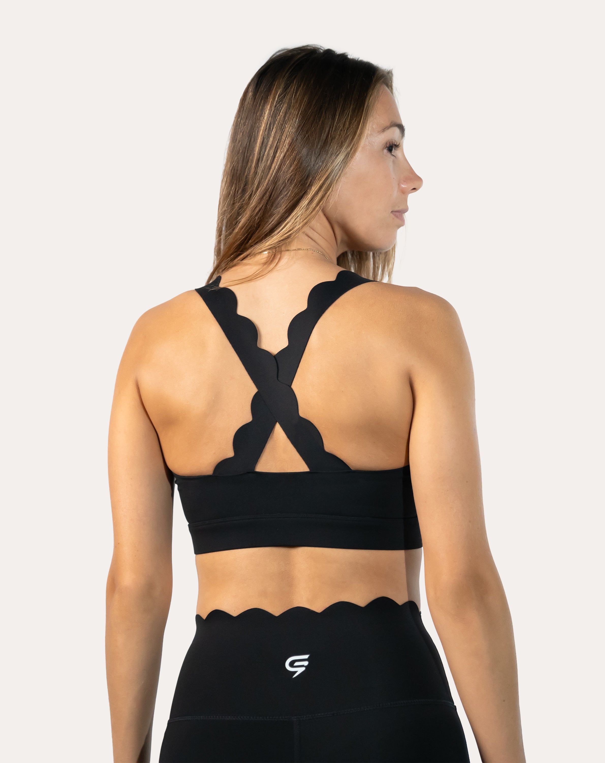 Back close-up of black seamless gym set bra with supportive cross-back straps
