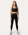Front full-length view of black seamless gym set with scallop-trim bra and high-waist leggings