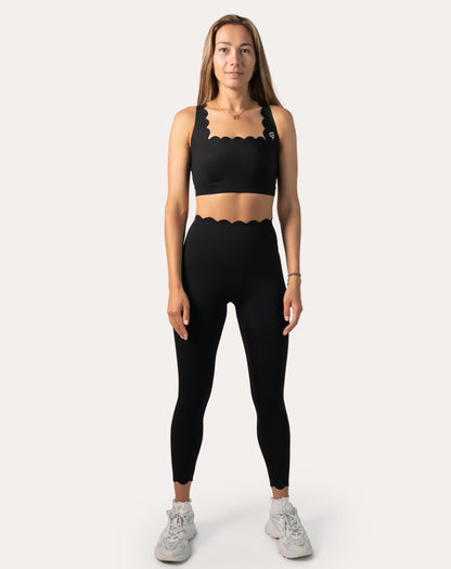 Front full-length view of black seamless gym set with scallop-trim bra and high-waist leggings