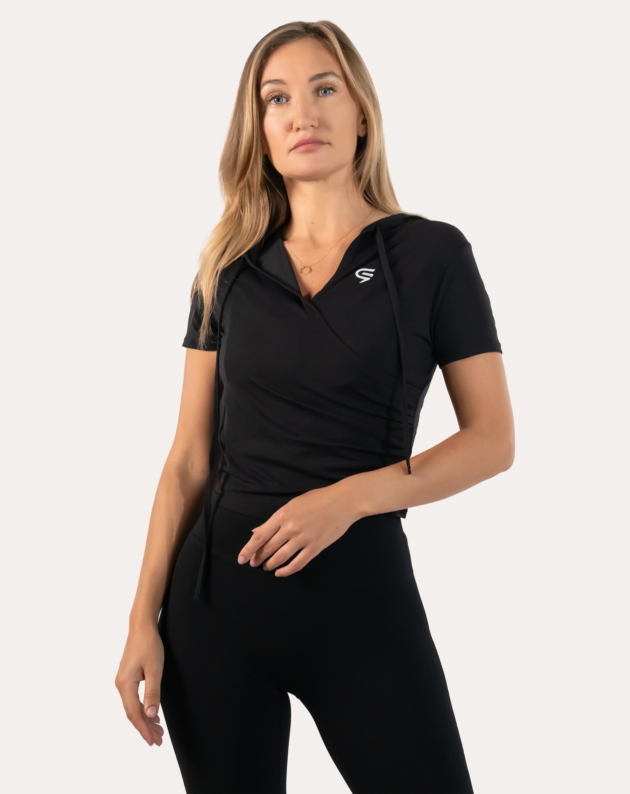 Black short sleeve gym top for women, straight front view with wrap-front hoodie design