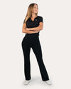 Full-length front view of black short sleeve gym top for women with cropped, body-hugging fit