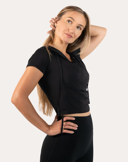 Side profile of black short sleeve gym top for women highlighting ruched side panels