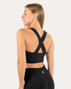 Right back three-quarter view of black sports bra showing cross-back straps and supportive underband