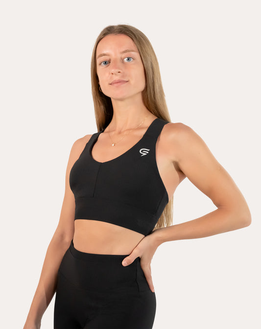 Front view of black sports bra in seamless micro-rib knit with a wide underband