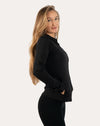 Back right three-quarter view of black women’s zip-up jacket highlighting sculpted seams