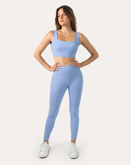 Blue gym set, front full-length with hands on hips; supportive bra and high-waist leggings
