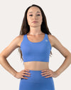 Straight-on front mid-length view of the blue sports bra with smooth scoop front.