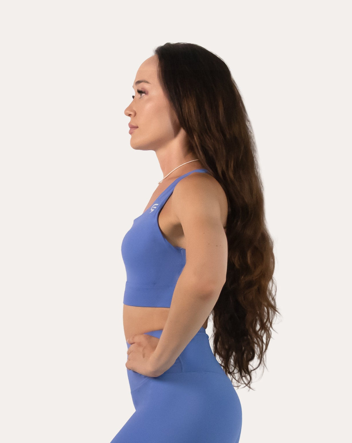 Right side profile of the blue sports bra showing wide straps and supportive band