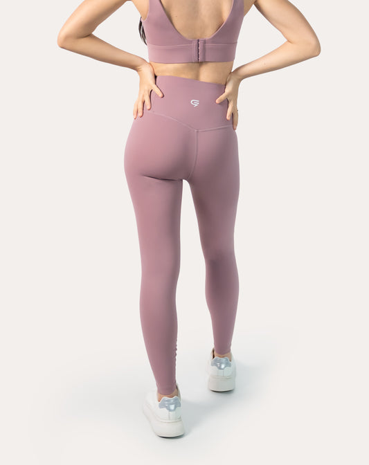 Back view showing secure high-rise waistband and contour seam on mauve-pink high-waisted leggings