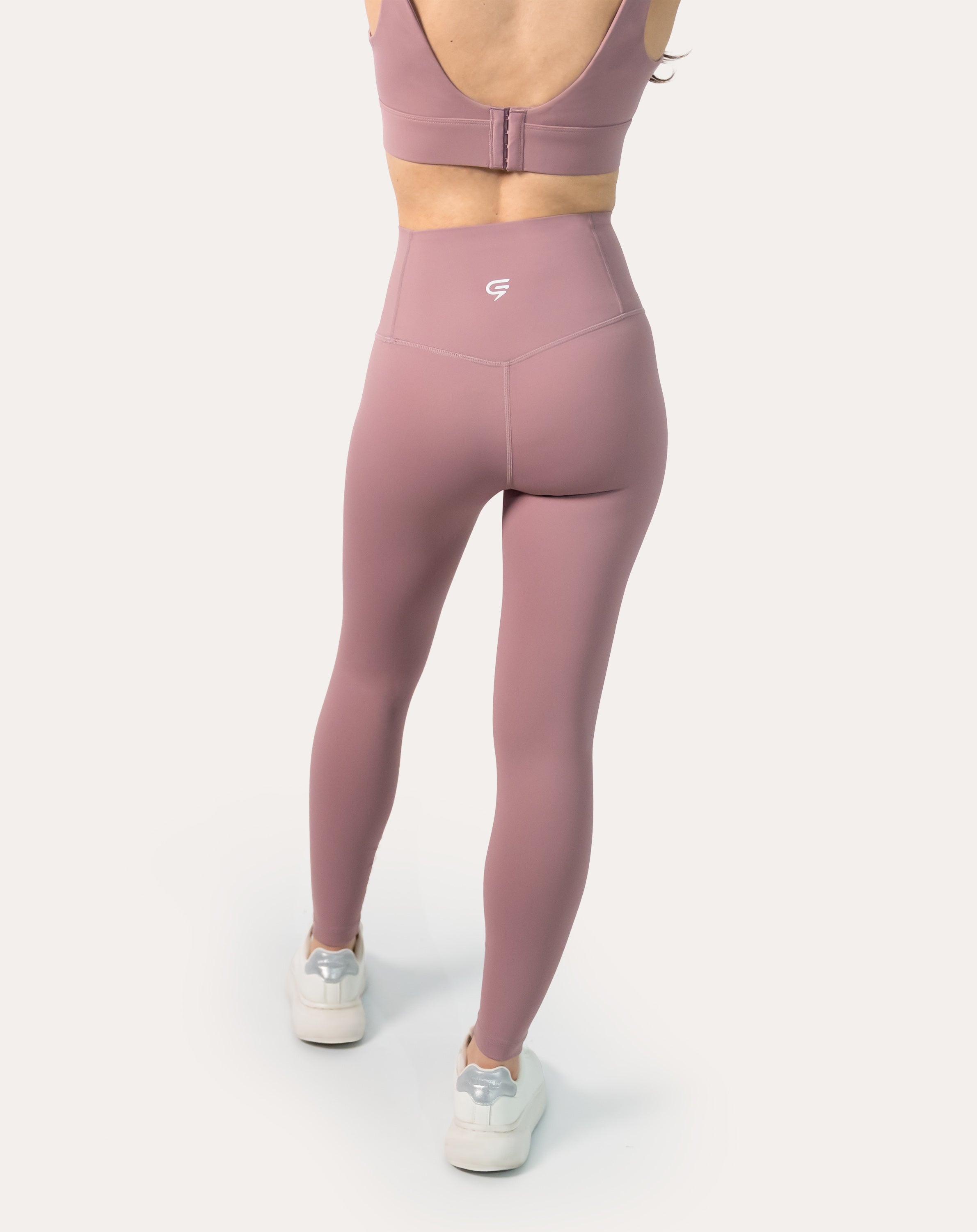 Rear angled view of mauve high-rise leggings with stay-put waistband and seamless, sleek look.