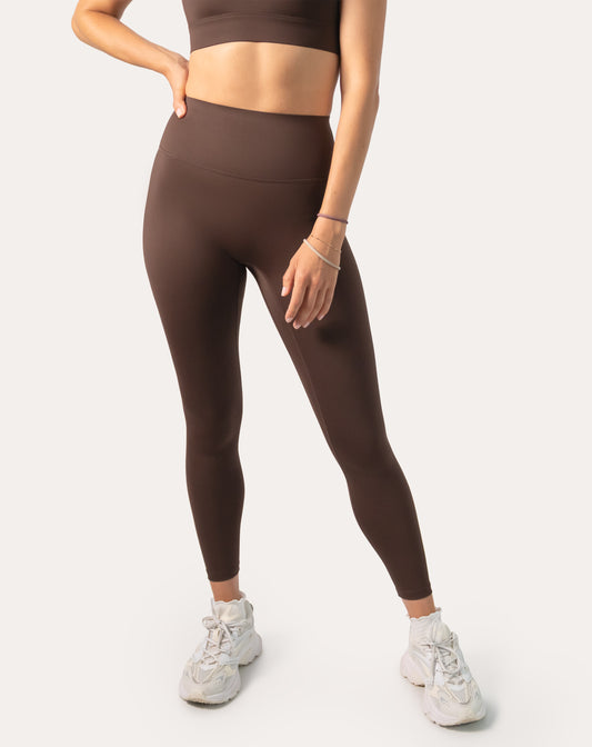 Chocolate brown sports leggings; front right three quarter view, sleek 7/8 length
