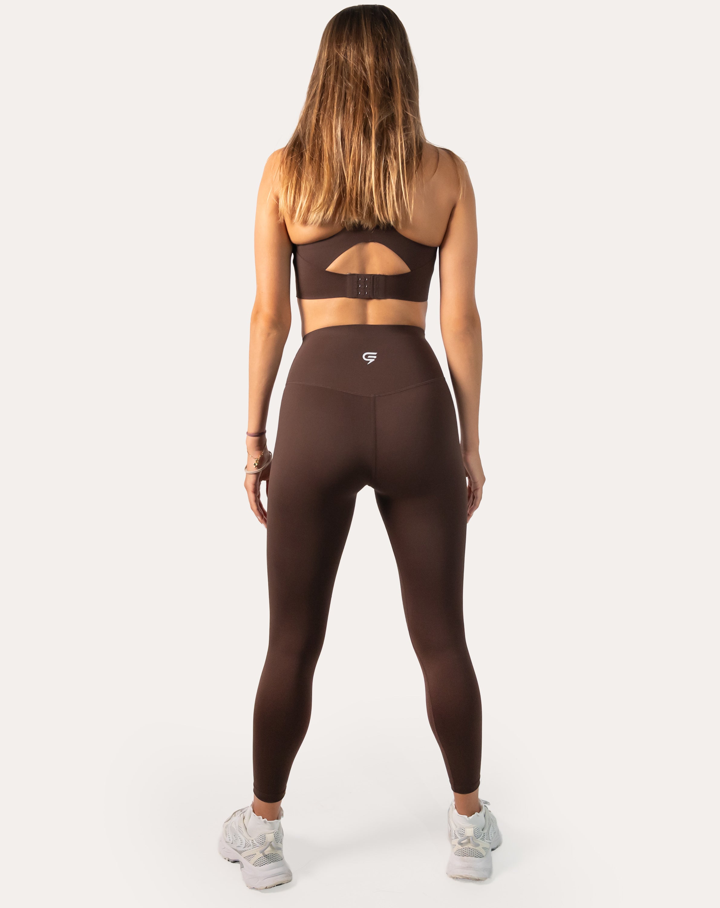 Chocolate brown sports leggings with high-rise waistband; back full-length view