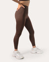 Chocolate brown sports leggings with high-rise support, 7/8 length; left three quarter view