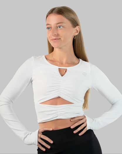 White gym top, ruched long-sleeve crop in three-quarter front view with front cut-out