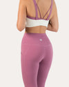 Back three-quarter close-up of white/lilac women’s sports bra showing lilac straps and open back