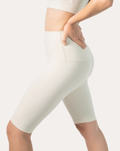 Close-up of cream biker shorts waistband smooth, squat-proof fabric and seams.