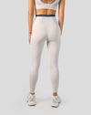 Full-body back view of cream leggings with V-contour seam and high-waist band