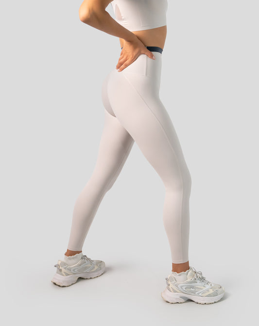 Left three-quarter close-up of cream leggings with V-contour high-waist fit