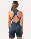 Deep blue women’s jumpsuit with racerback straps; straight back view