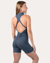 Deep blue women’s jumpsuit with racerback straps; back right three quarter view
