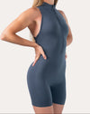 Deep blue women’s jumpsuit with zip front; left three quarter view
