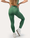 Back view of emerald green gym set with one-shoulder bra and high-waist leggings