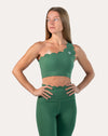 Full-length front of emerald green gym set, hands on hips; one-shoulder scallop bra with leggings