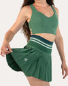Side view while moving of the forest green longline sports bra; V-neck and longline band visible