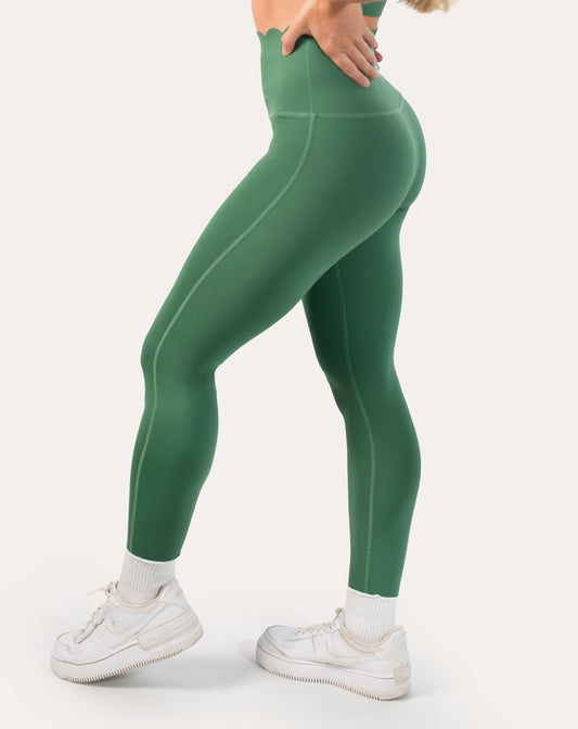 Forest green leggings with scallop high-waist, ankle length; left three quarter view