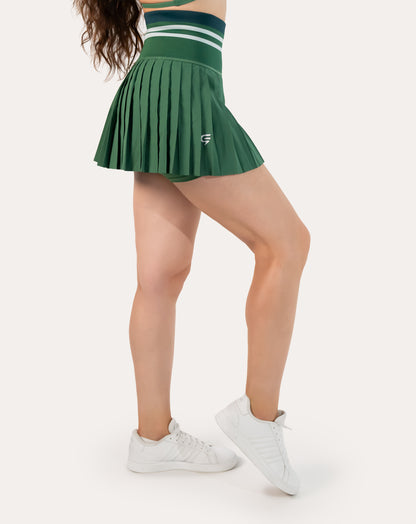 Front three-quarter close-up of forest green pleated tennis skirt with high-waist striped band
