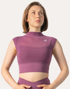 Close-up of the high neck gym top in purple highlighting the mock neck, cap sleeves and sculpting crop silhouette