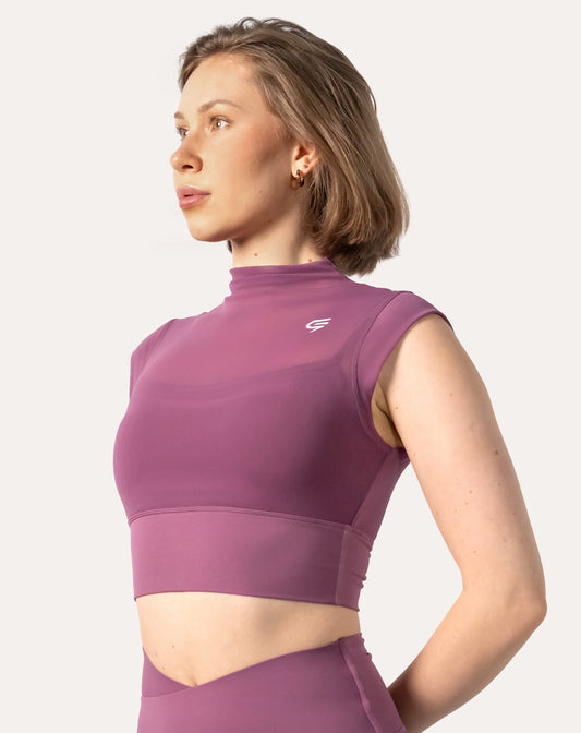 Three-quarter front view of a high neck gym top in purple with cap sleeves; cropped fit with smooth front panel