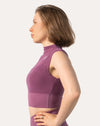 Side profile of the high neck gym top showing the cropped underband, cap sleeve and smooth performance fabric