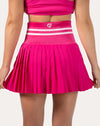 Close-up of hot pink gym set skirt back with high rise elastic waistband and pleats.