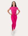Hot pink running leggings with pockets; front full-length view, hands on hips