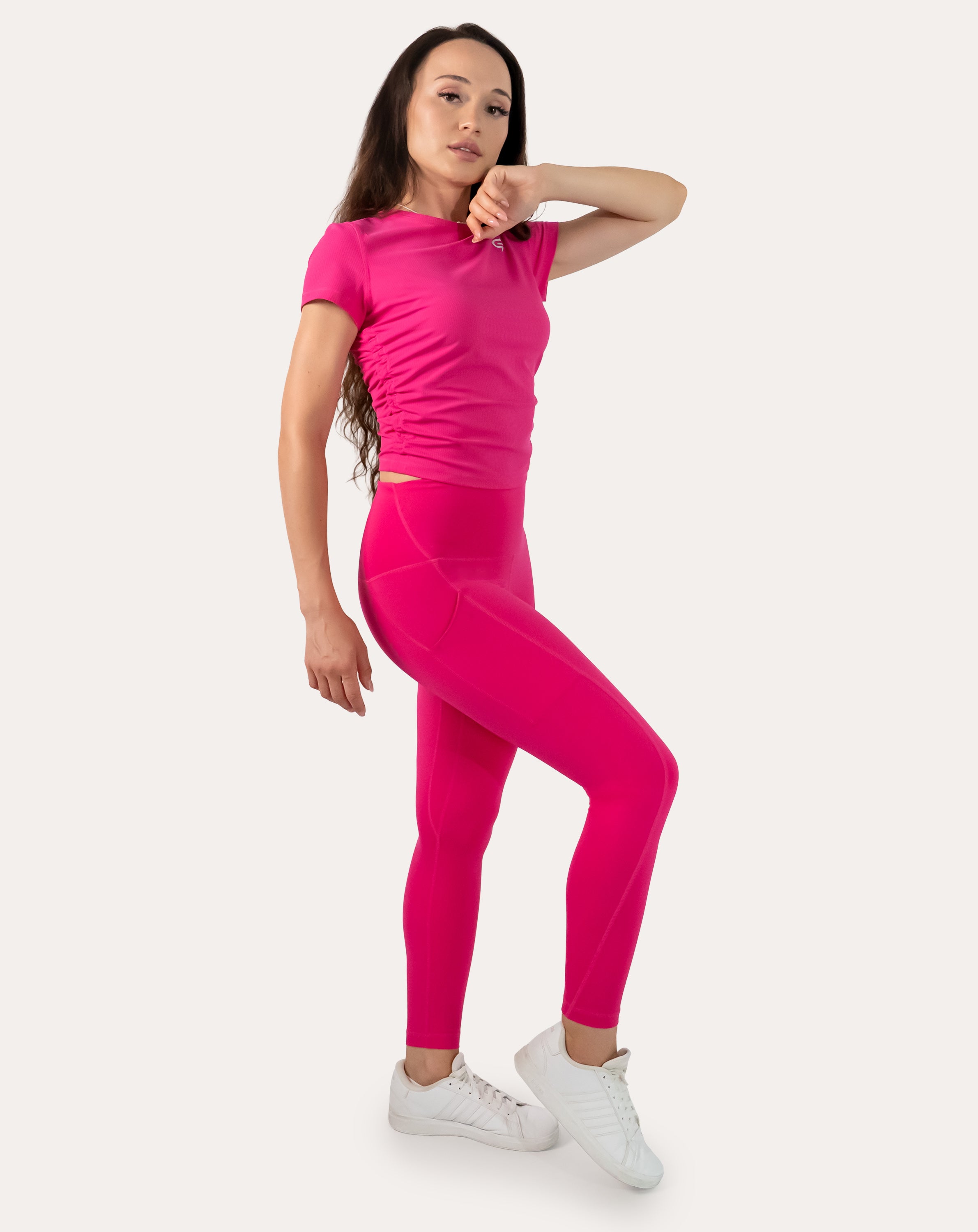 Hot pink running leggings with pockets; right three quarter front stance