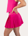 Right side view of hot pink tennis skirt highlighting crisp pleats and A-line drape