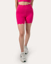 Front view of hot pink yoga shorts in biker length with a scalloped hem