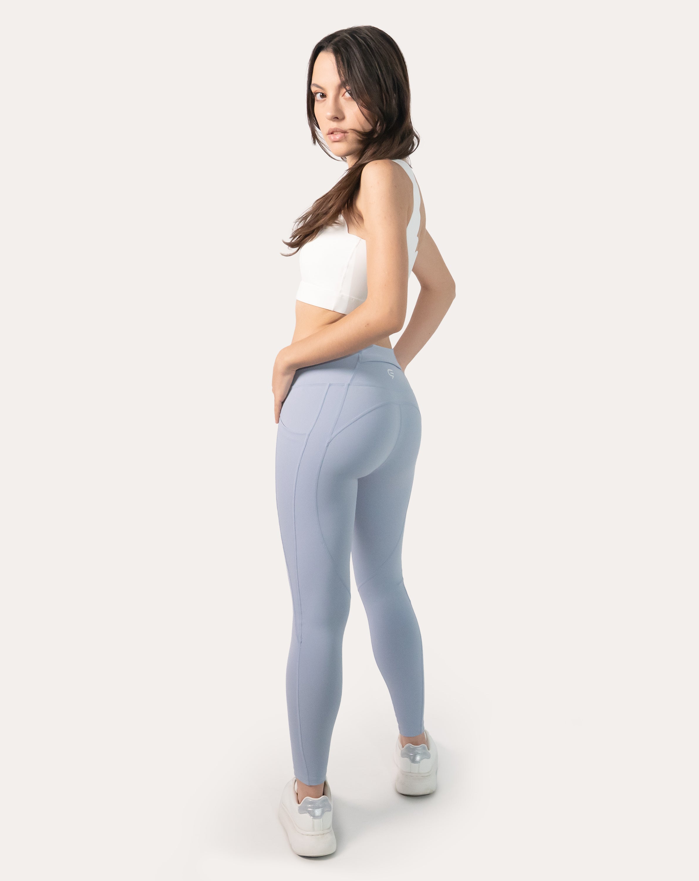 Full-body back view of ice blue high-waist leggings with phone pocket and ankle-grazing cut