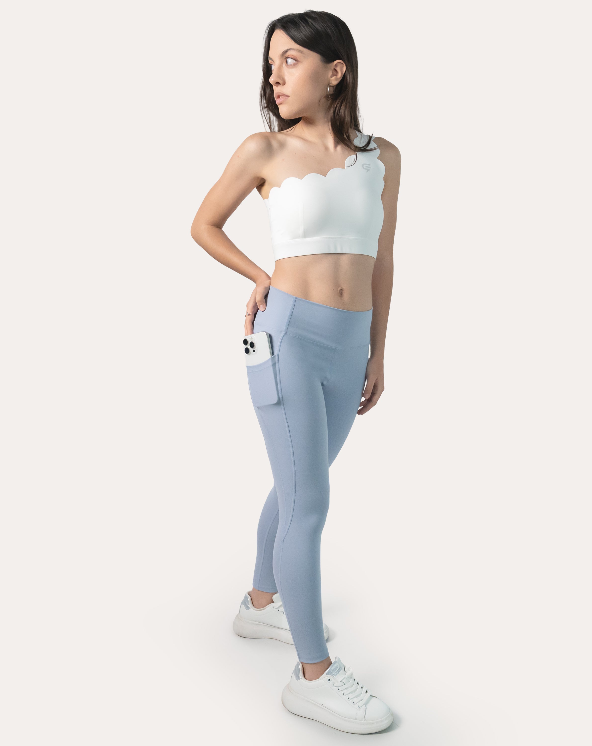 Front three-quarter view of ice blue leggings with phone pocket and light-compression fit