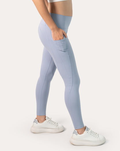 Right side angle with hand in the side phone pocket on ice blue high-waist leggings