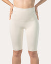 Front view of ivory high-waist longline bike shorts with smooth, opaque coverage.