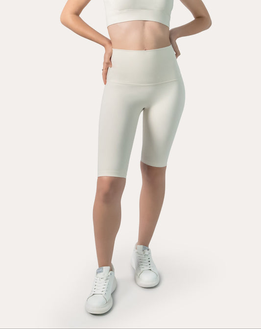 Front three-quarter view of ivory bike shorts with high-waist band and longline length